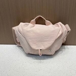 Lululemon curved crossbody bag pink color